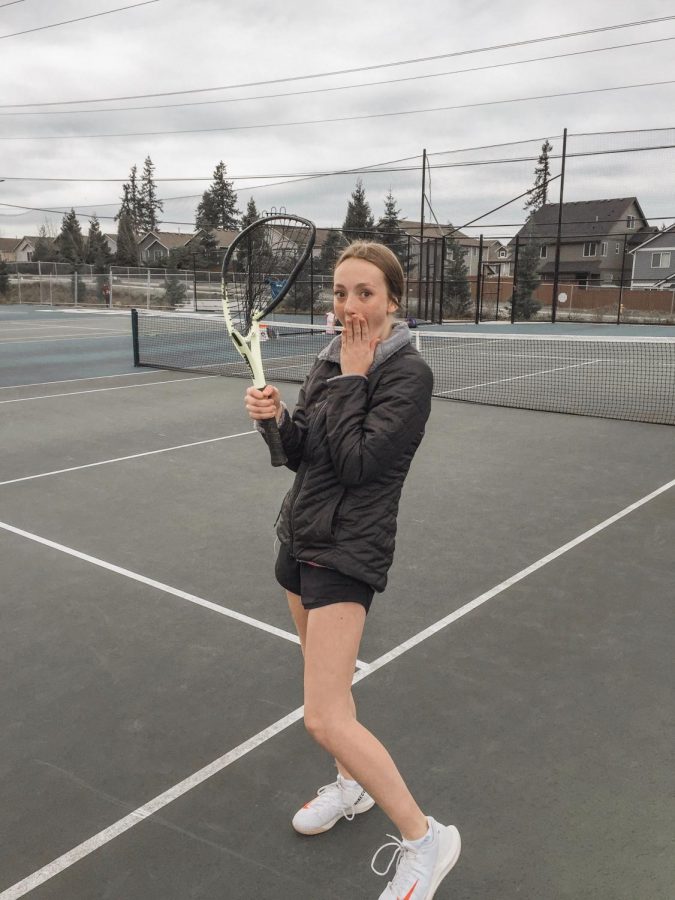 Student, Lauren Tomich posing for a photo at Tahoma High School tennis court before practice.