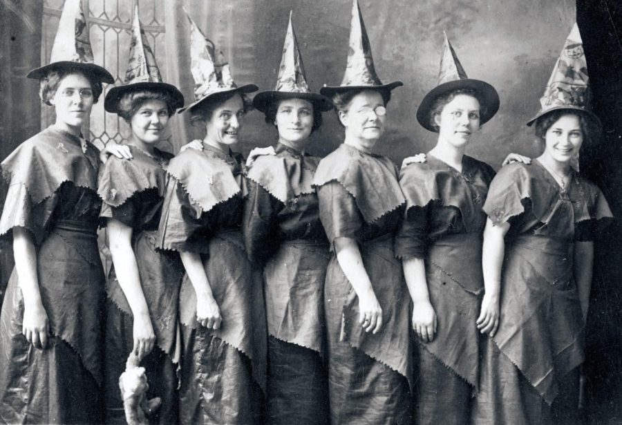 A group of women dress up as witches in the early 1910s.