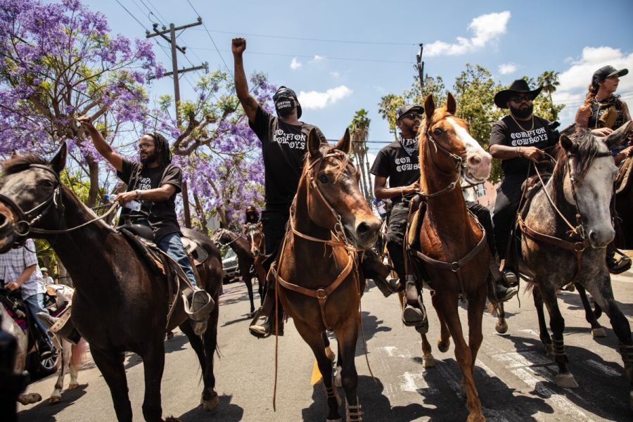The+Compton+Cowboys+ride+down+South+Tamarind+Avenue%2C+along+with+hundreds+of+people+marching%2C+during+the+Compton+Peace+Ride+on+June+7.++%28Jay+L.+Clendenin+%2F+Los+Angeles+Times%29%0A